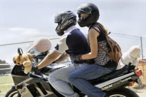 riding a motorcycle with a passenger