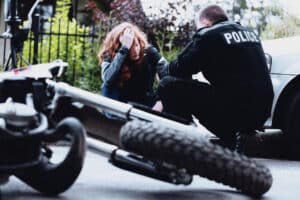 police talking to a woman after a motorcycle accident