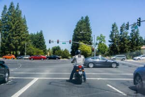 motorcycle waiting to make a left turn at an intersection