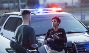 police officer talking to a witness at a motorcycle accident scene