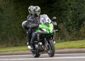 motorcycle rider with a passenger on back