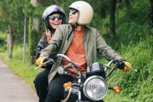 young couple riding on a motorcycle