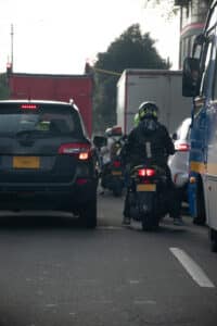 motorcycle riders lane splitting in city traffic