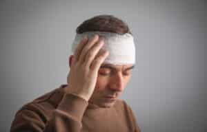 man with a bandage on his head from a brain injury in a motorcycle accident