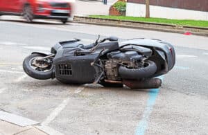 motorcycle lying on the street after a crash