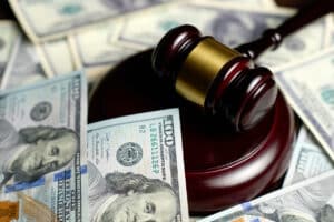 judge's gavel and money after a motorcycle accident settlement