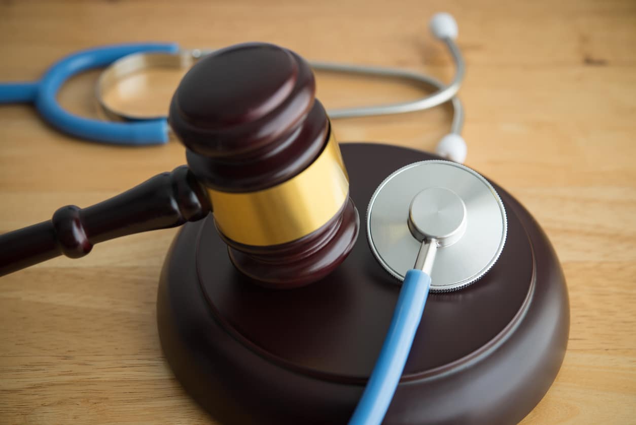 gavel and stethoscope on wooden table in a personal injury law office