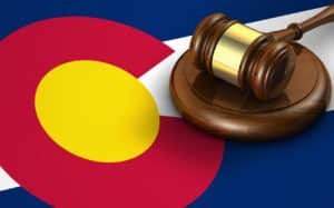 Colorado personal injury law concept - judge's gavel on a Colorado flag